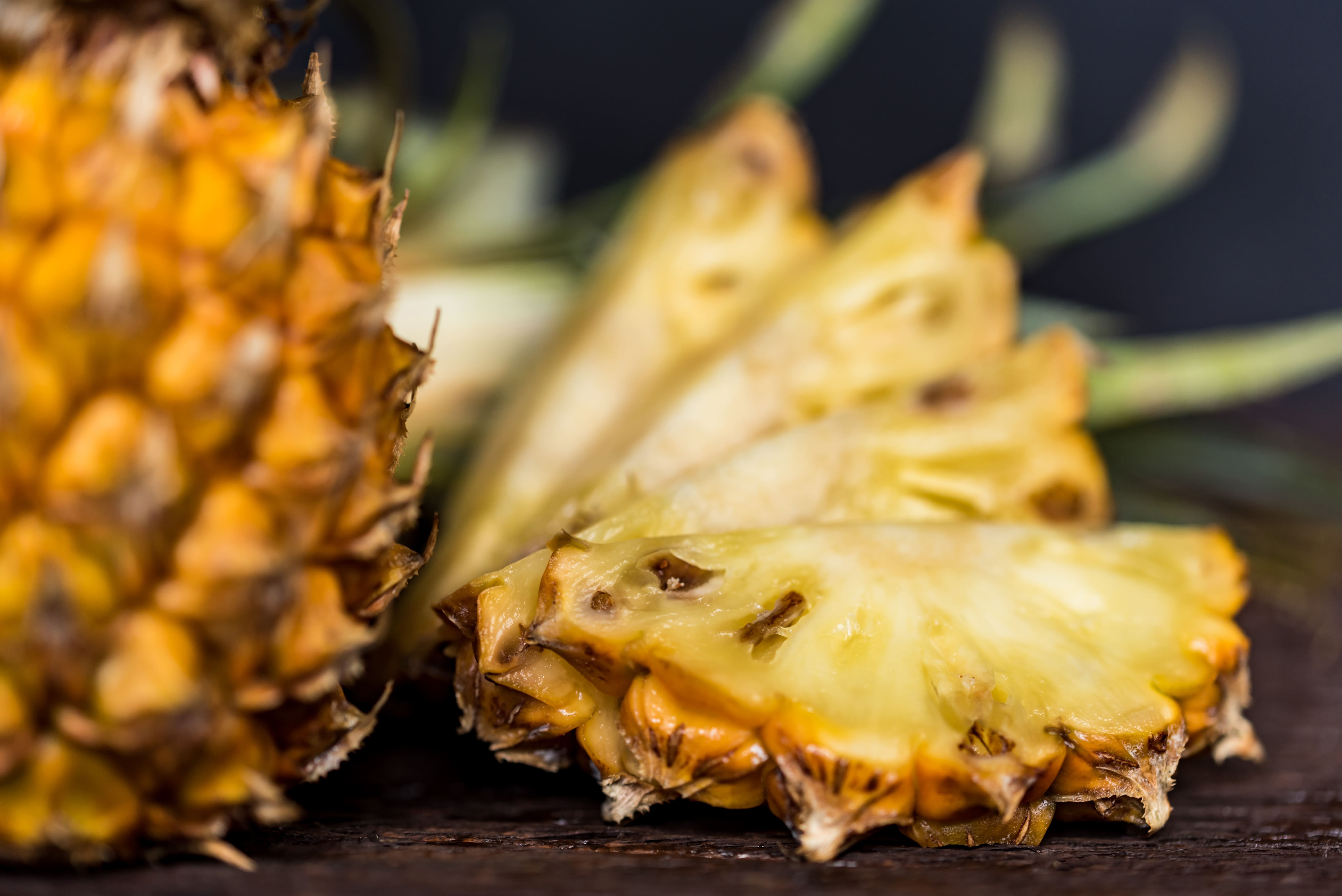 pineapples-on-a-dark-wooden-background-X4FHN6C-min