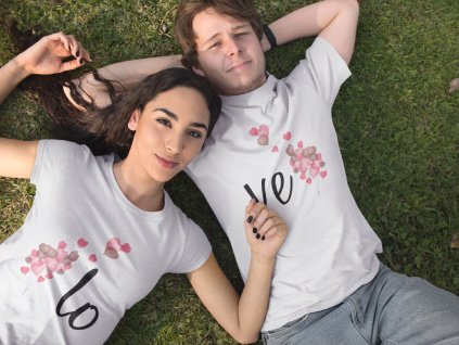 pretty young couple lying down in the park while wearing different t shirts mockup a15317