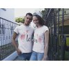 young couple smiling while wearing t shirts mockup with different designs on the street a15789