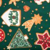 Detail látky so zeleným podkladom a motívom vianočných perníkov, stromčekov a hviezd