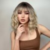 Blond vlnitá krátká paruka Olivie s tmavými kořínky a ofinou
