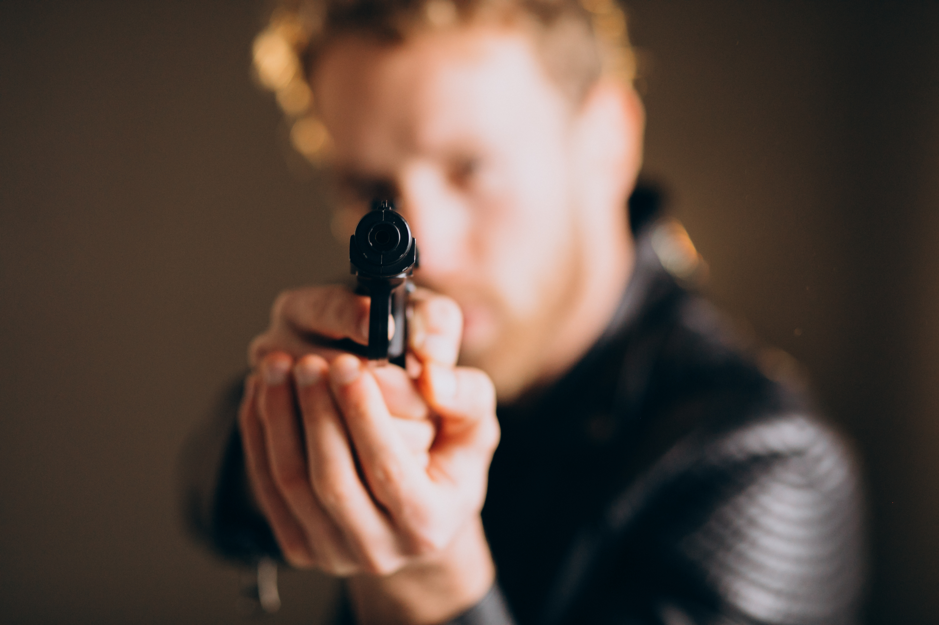 handsome-man-actor-posing-studio-with-weapon