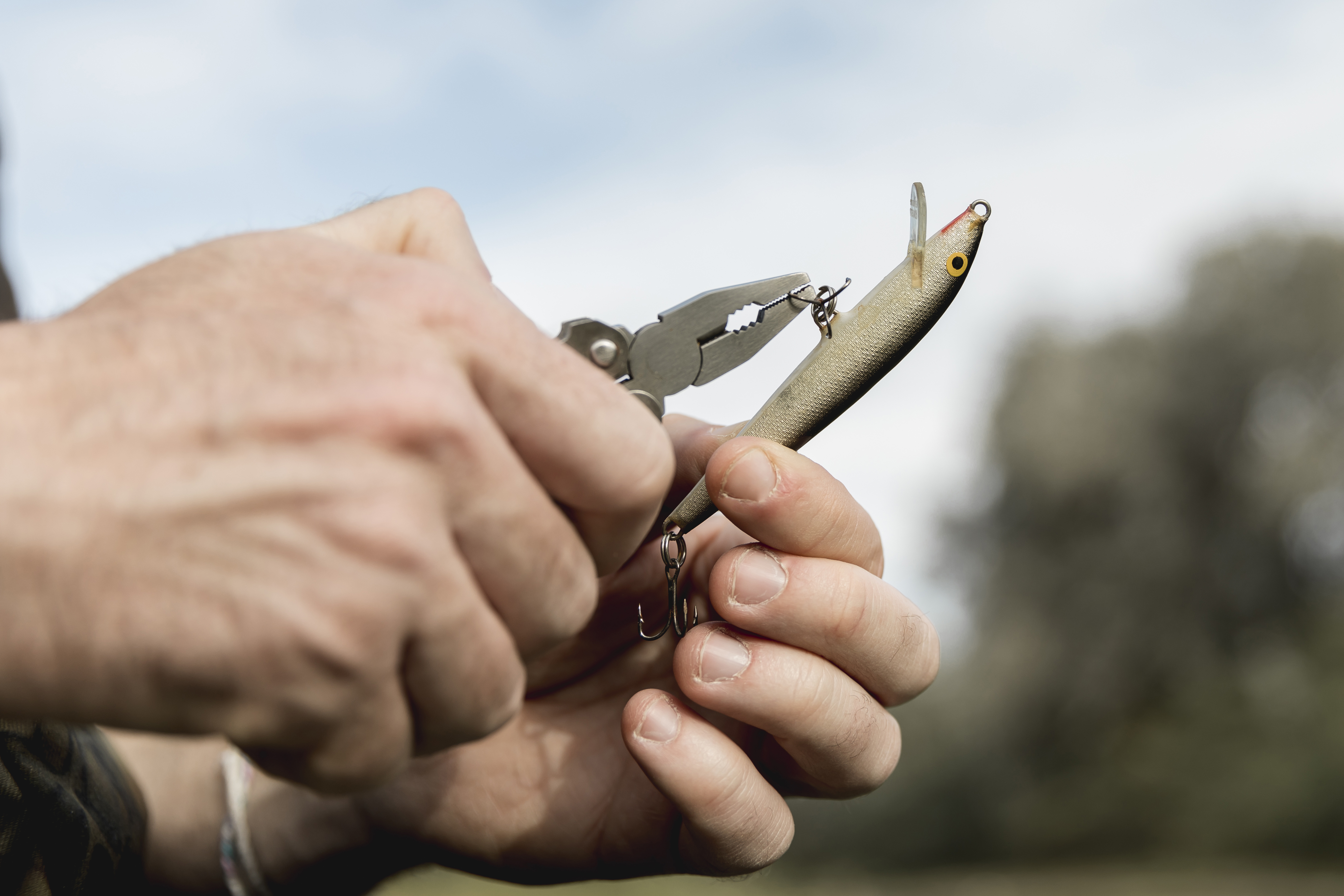 person-fixing-fish-hook