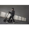 1225 11 f2 pro ii lifestyle picture guy with helmet walking with ekickscooter