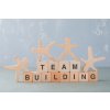 team building concept with wooden blocks wooden human figures it side view