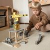 Pohyblivý přístavní jeřáb s magnetickým navijákem a doplňky  Objevte hračku, která přináší hodiny tvořivé zábavy! Tento dřevěný přístavní jeřáb s magnetickým navijákem je perfektní volbou pro malé stavitele a milovníky vlaků, lodí a techniky. Děti se díky němu přenesou do rušného přístavu, kde mohou nakládat a vykládat kontejnery, řídit pohyb vozidel a vymýšlet nekonečné herní scénáře.  Realistická zábava jako v opravdovém přístavu Hlavním prvkem sady je velký, dvoupatrový, otočný jeřáb, který se může otáčet o 360°. Je vybaven pohyblivým ramenem a silným magnetem na konci navijáku, díky kterému lze snadno zvedat dřevěné kontejnery. Děti mohou přesouvat náklad z loďí na vagony nebo kamion a zpět – přesně jako skuteční pracovníci v přístavu!  Jeřáb umožňuje pohyb nahoru–dolů i dopředu–dozadu, čímž podporuje rozvoj přesnosti a koordinace pohybů.  Bohatá sada příslušenství Součástí balení je vše potřebné pro okamžitou hru: - 1 velký, pohyblivý přístavní jeřáb s navijákem a magnetem - 1 lokomotiva - 2 vagony - 1 kamion - 1 přívěs - 1 loď – nákladní frachtovní loď pro 12 kontejnerů - 12 magnetických kontejnerů Základní deska má otvory pro koleje, takže lze sadu snadno rozšířit o další železniční prvky a vytvořit celý přístavní komplex.  Vzdělávací přínosy Tato hračka je nejen zábavná, ale také rozvíjí mnoho důležitých dovedností: - rozvíjí oko-ruka koordinaci - trénuje přesnost a trpělivost - podporuje kreativitu a prostorovou představivost - posiluje sebedůvěru dítěte - učí pečlivosti a logickému myšlení  Bezpečná a ekologická Jeřáb je vyroben z jalovcového a lipového dřeva a MDF desky. Všechny části mají hladké, zaoblené hrany a jsou natřeny netoxickými barvami. Hračka splňuje přísné evropské normy CE a EN71, takže je zcela bezpečná pro děti a zároveň šetrná k životnímu prostředí.  Specifikace: - Věk: od 3 let - Rozměry: 24 × 34 × 35 cm - Materiál: jalovcové a lipové dřevo, MDF, kov, plast - Obsah sady: jeřáb, lokomotiva, 2 vagony, kamion, přívěs, loď, 12 kontejnerů - Certifikáty: CE, EN71  Tento pohyblivý přístavní jeřáb není jen hračka – je to malý svět techniky, logistiky a fantazie, který rozvíjí dovednosti i představivost každého malého objevitele.