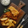 top view fish chips chopping board with cutlery