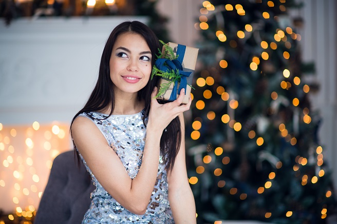 excited-woman-in-christmas-night-sitting-near-MS3UGKW