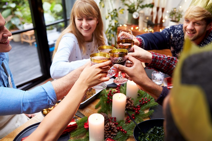 group-of-friends-sitting-around-table-at-home-for-2VQAXYU