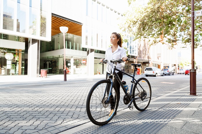 portrait-of-happy-young-female-bicyclist-PMZWRMP