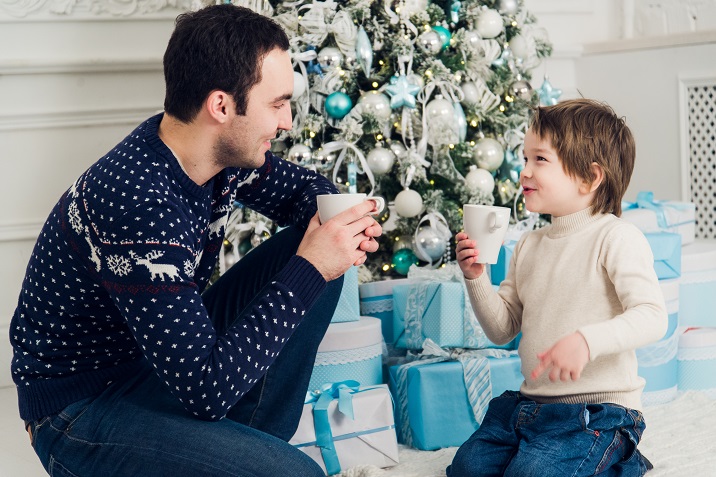 happy-dad-and-son-with-cups-of-tea-talking-near-PHSEJY7