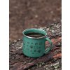mockup of a 12 oz enamel mug with a silver rim placed on a fallen tree 30820 (6)