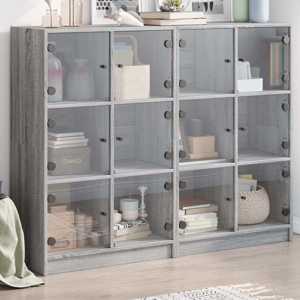E-shop Multidom Knižnica s dvierkami sivá sonoma 136x37x109 cm kompozitné drevo