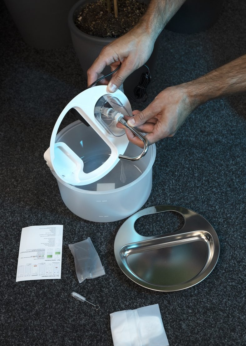 Attaching the spout to the lid of the Myers PFN-A2 pet fountain by hand, no tools needed