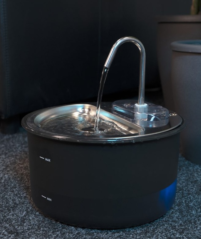Water flowing from the spout of the Myers PFN-A2 pet fountain into the stainless steel bowl