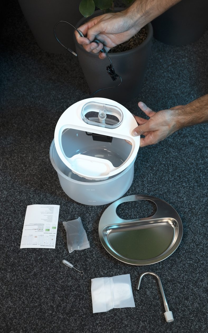 Smart Pet Fountain Myers PFN-A2 unboxed with its filter, cleaning brush, cable, and stainless steel bowl laid out