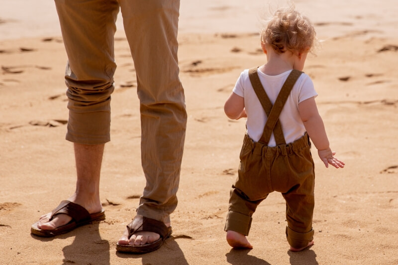 Kid adult, barefoot, walking