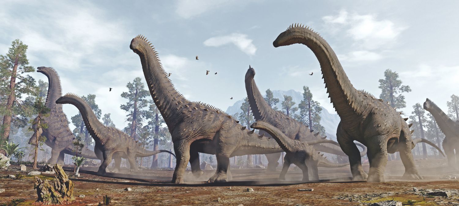Obří býložraví dinosauři alamosauři dominují druhohorní krajině.