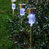 Sada 8 LED solárních lamp - bílá na zahradě