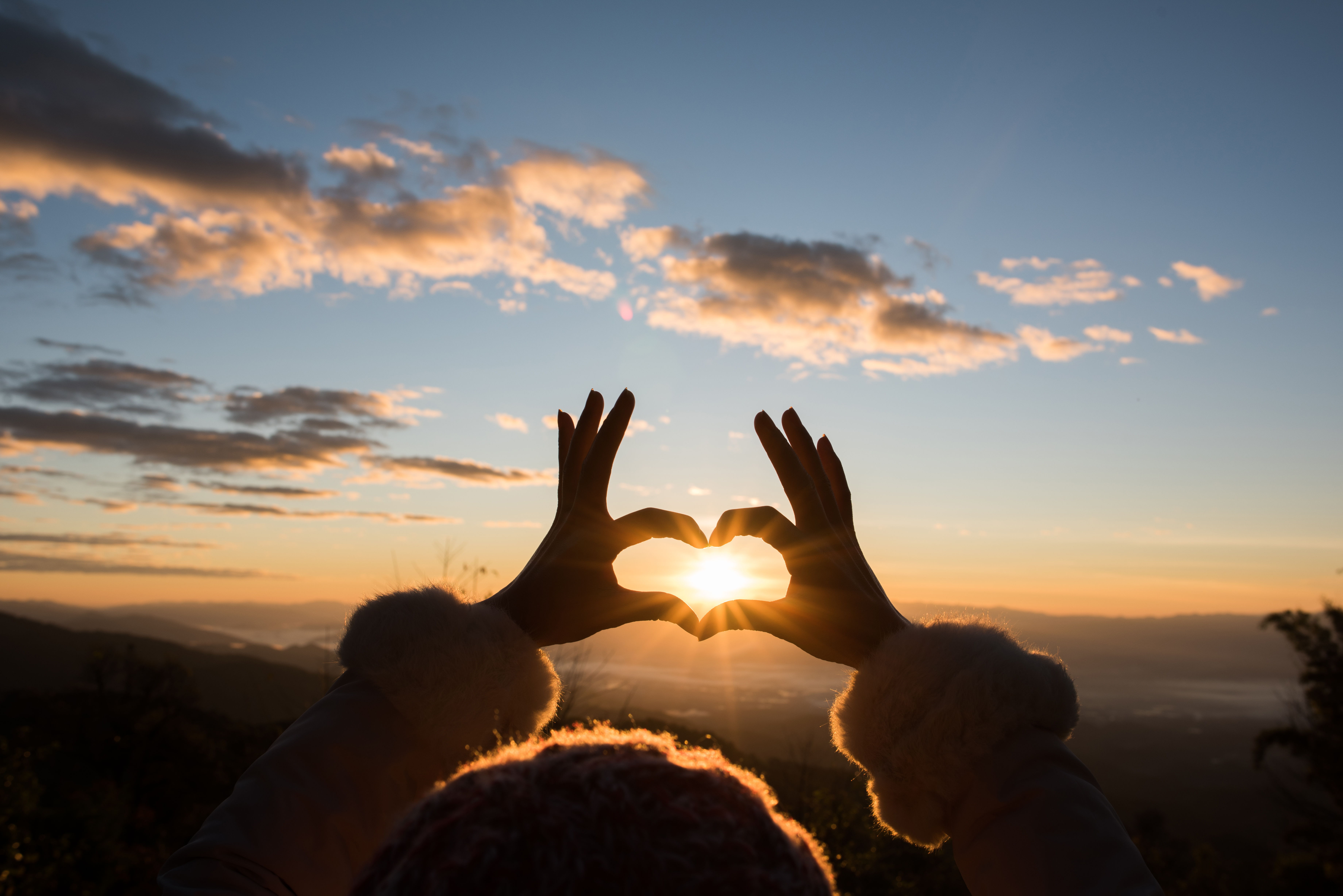 silhouette-hands-forming-heart-shape-with-sunrise