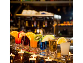 side view cocktail shots with slice lemon kiwi slice candles bar