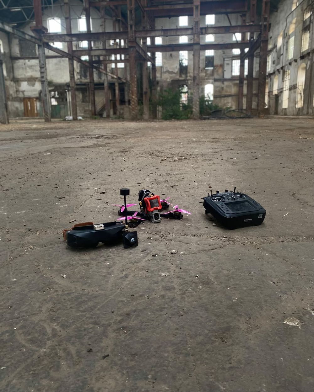 A 5-inch freestyle drone, goggles and radio in an abandoned hall
