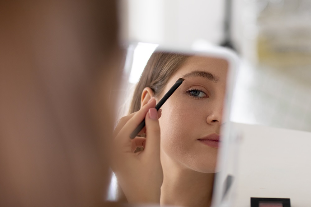 front-view-girl-doing-her-eyebrows