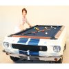 A Shelby Pool Table with a lady next standing next to it