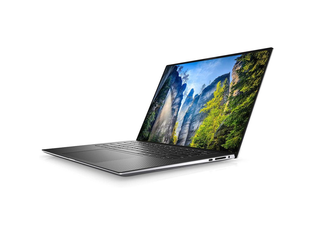 Otevřený Dell notebook se skálou a modrou oblohou na tapetě.