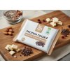 Create a nice image in a healthy snack setting with the cacao nibs and white chocolate protein cooki