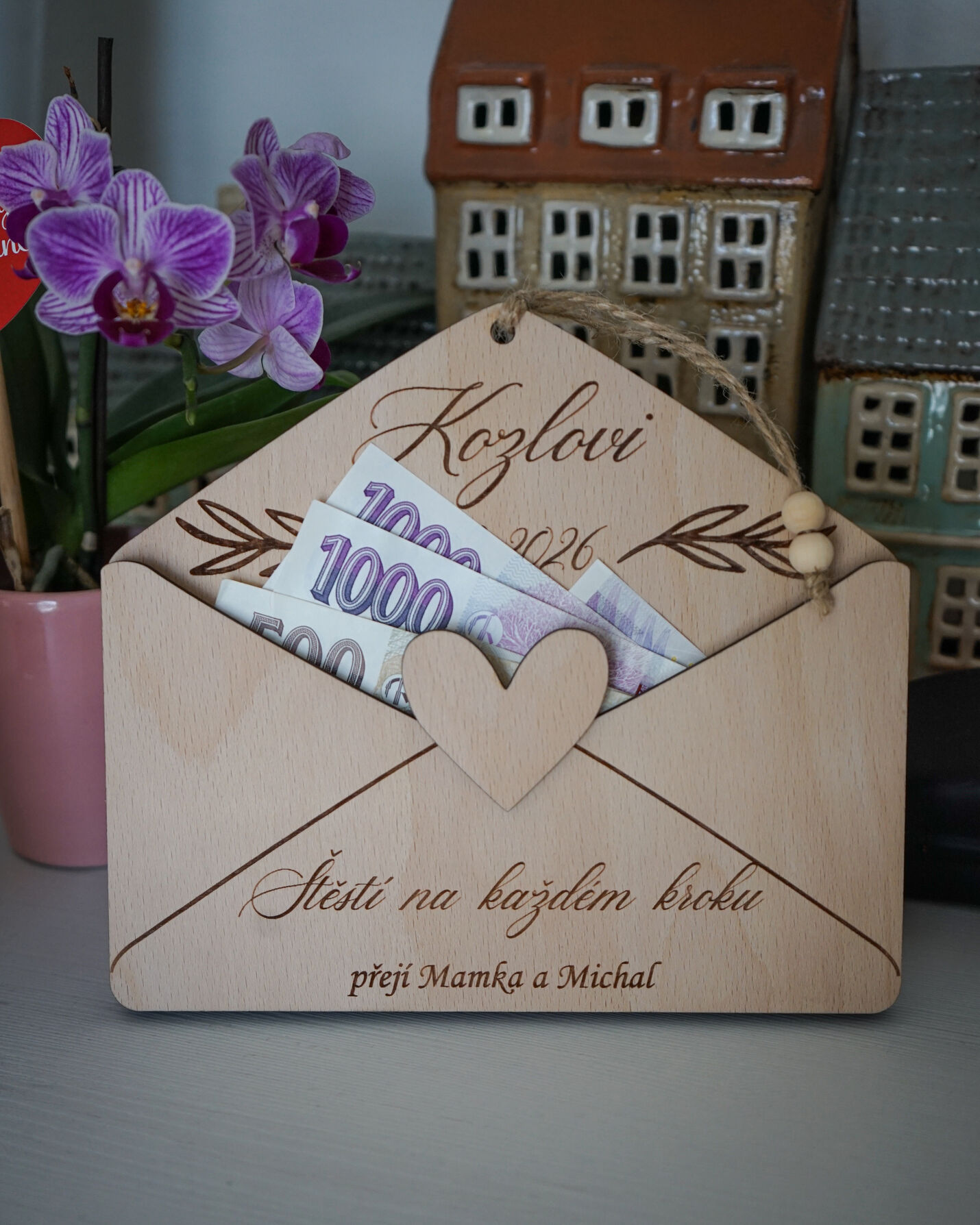 Detailní záběr na vygravírovaná jména a vložené bankovky