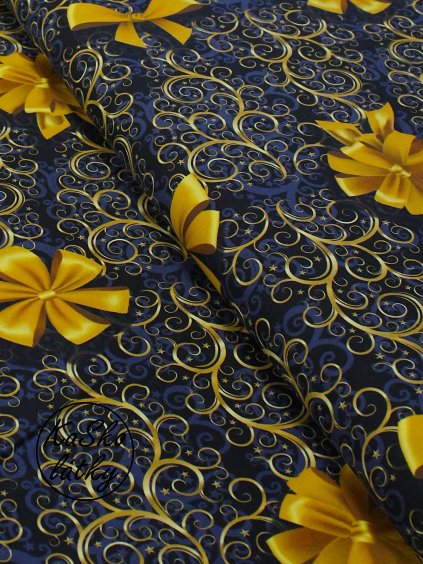 Bavlněná látka zlaté mašle na modré