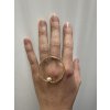 Women's gold-plated Implicate ring across the hand with a pearl