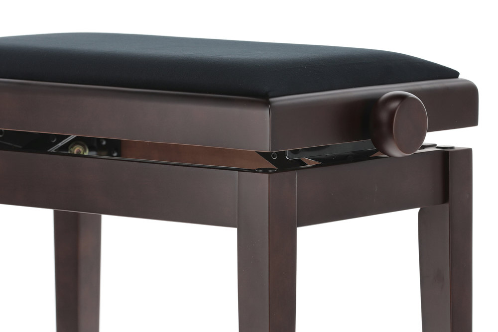 Kolečko k ovládání výšky klavírní stoličky.