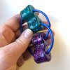 fidget loopeez stor turkos lila rod i en hand 40113