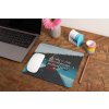 mockup of a mousepad lying on a rustic table next to a flower vase 27554