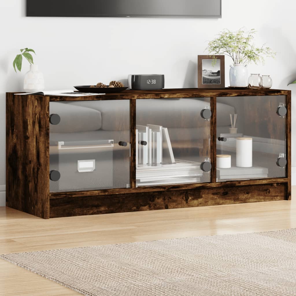 vidaXL TV skrinka so sklenenými dvierkami dymový dub 102x37x42 cm