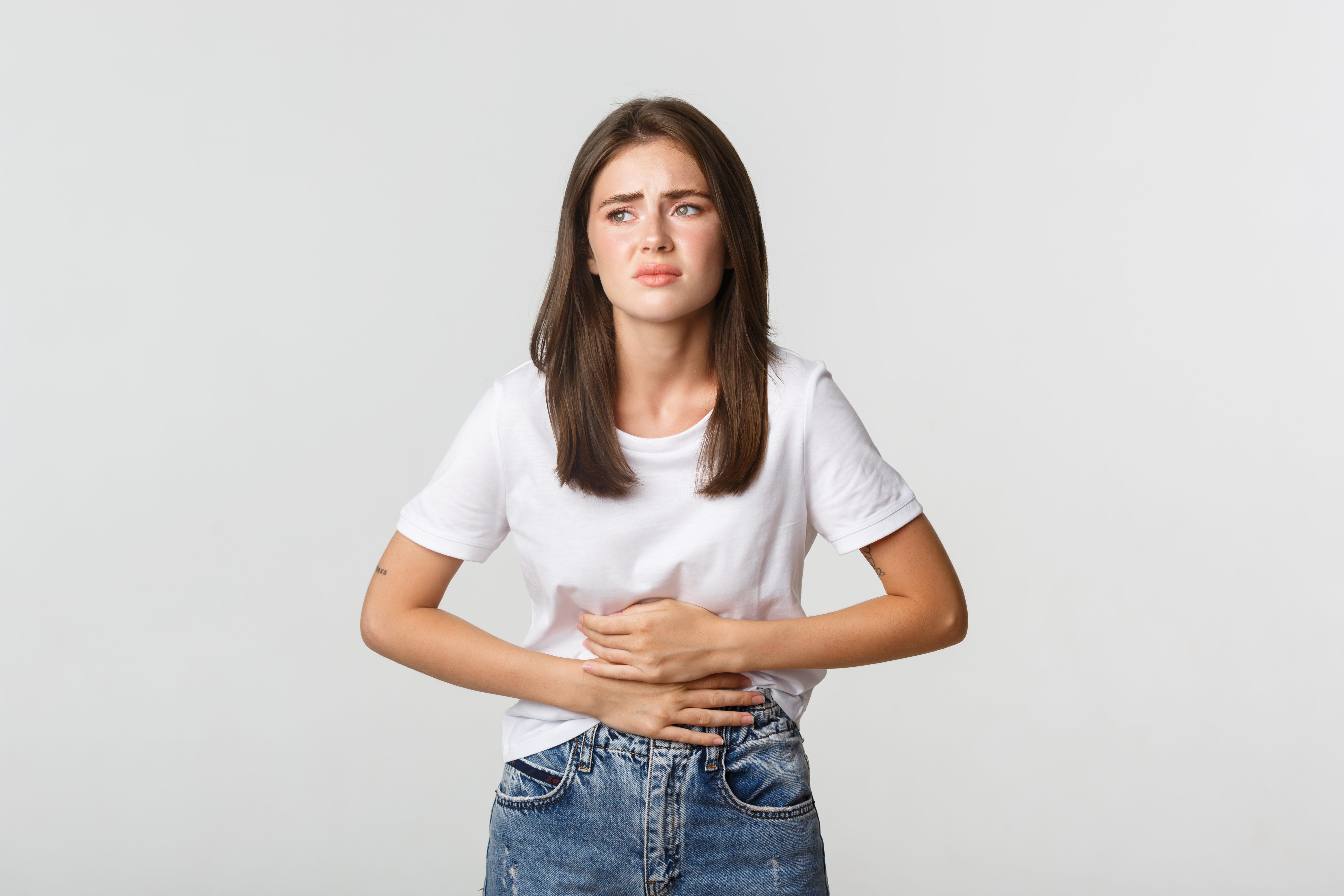 woman-having-stomach-ache-bending-with-hands-belly-discomfort-from-menstrual-cramps