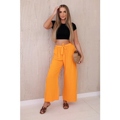 Nohavice so širokým strihom a viazaním v páse oranžové