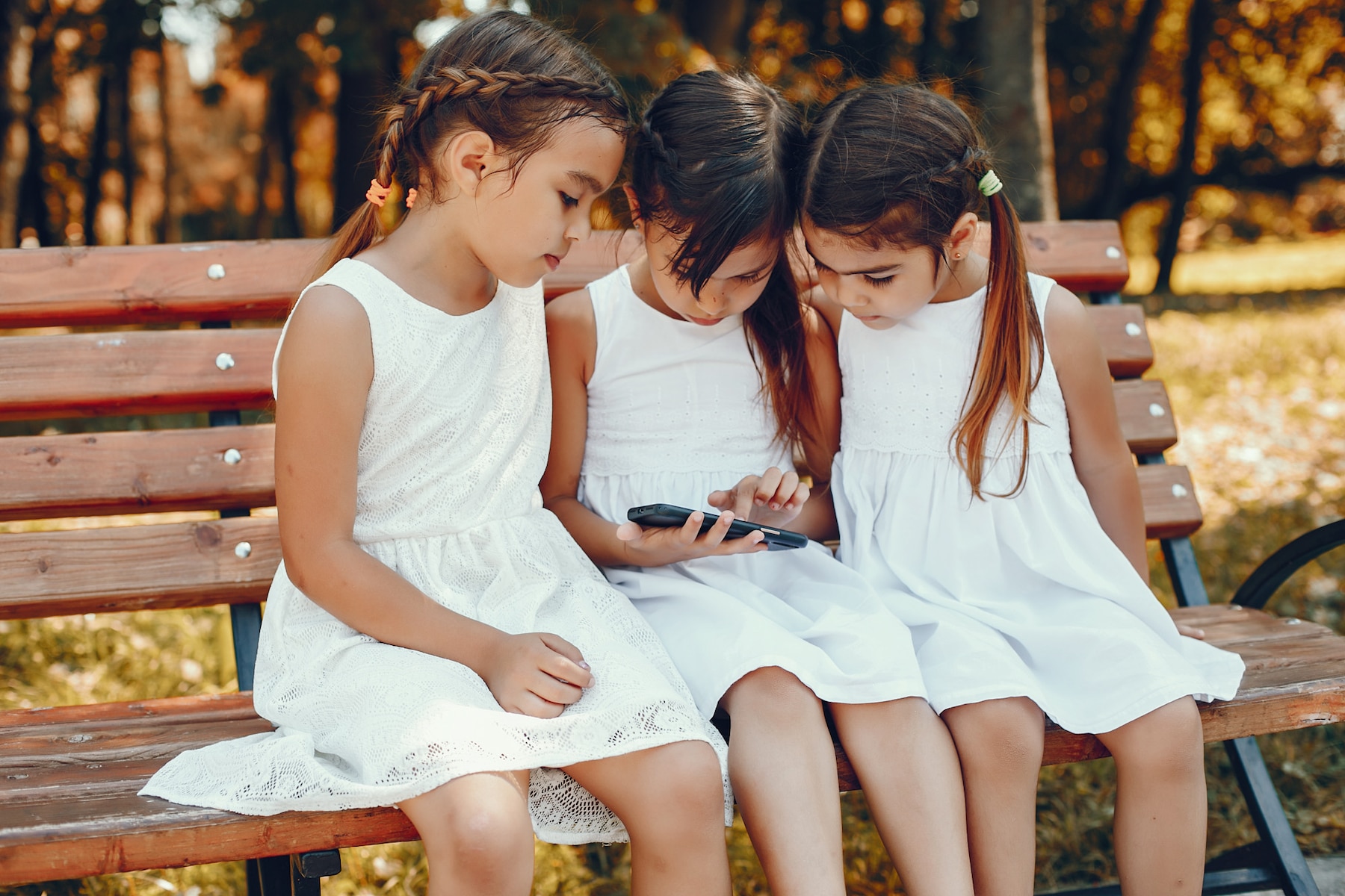 three-little-sisters-sitting-summer-park_1157-20264