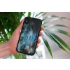 mockup of a woman holding a clear phone case in front of a houseplant 4636 el1 (14)