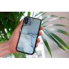 mockup of a woman holding a clear phone case in front of a houseplant 4636 el1 (3)