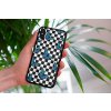 mockup of a woman holding a clear phone case in front of a houseplant 4636 el1