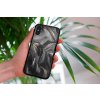 mockup of a woman holding a clear phone case in front of a houseplant 4636 el1 (9)