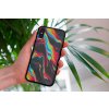 mockup of a woman holding a clear phone case in front of a houseplant 4636 el1