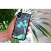mockup of a woman holding a clear phone case in front of a houseplant 4636 el1