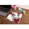 mockup of a mousepad lying on a rustic table next to a flower vase 27554