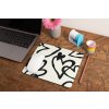mockup of a mousepad lying on a rustic table next to a flower vase 27554