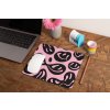 mockup of a mousepad lying on a rustic table next to a flower vase 27554
