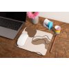 mockup of a mousepad lying on a rustic table next to a flower vase 27554